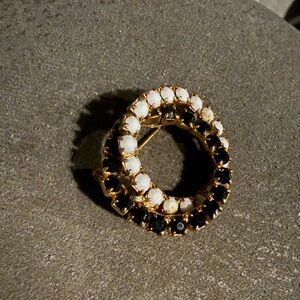 Elegant Gold and Black Circular Brooch